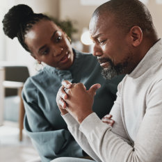 Sad, black man and stress with therapist for empathy, therapy session or mental health appointment. African, male person or patient crying with psychologist for counselling, support or consolidation