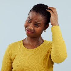 Confused, thinking and black woman scratching head in studio with why, brainstorming or solution on grey background. Questions, doubt and model with emoji gesture for problem solving, how or forget