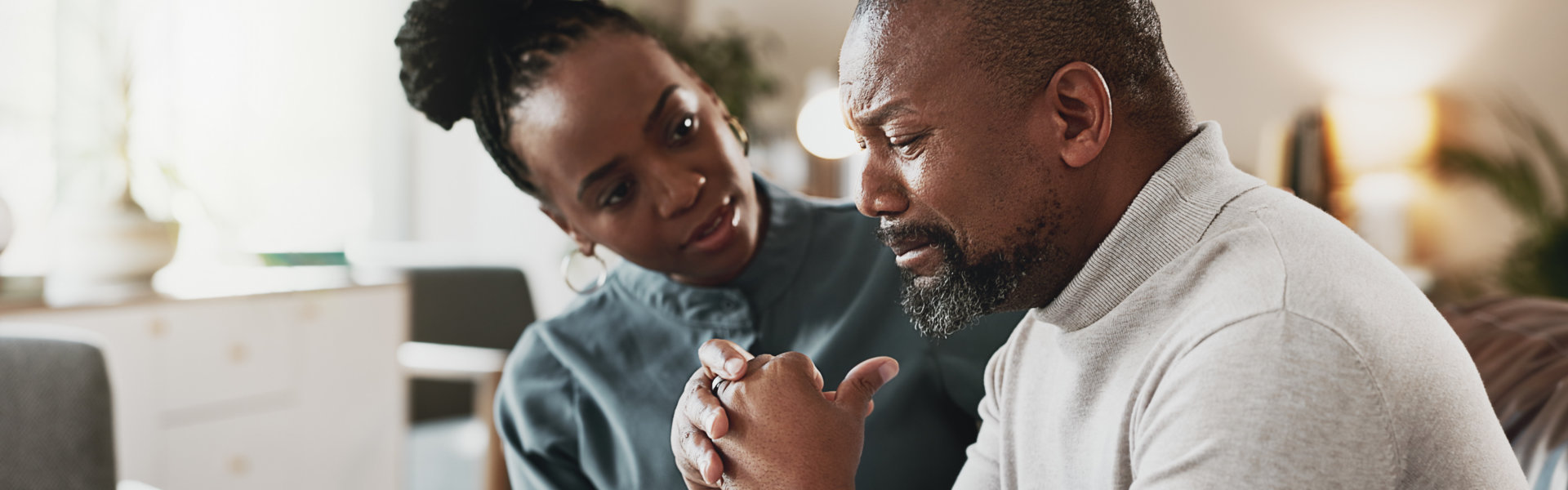 Sad, black man and stress with therapist for empathy, therapy session or mental health appointment. African, male person or patient crying with psychologist for counselling, support or consolidation