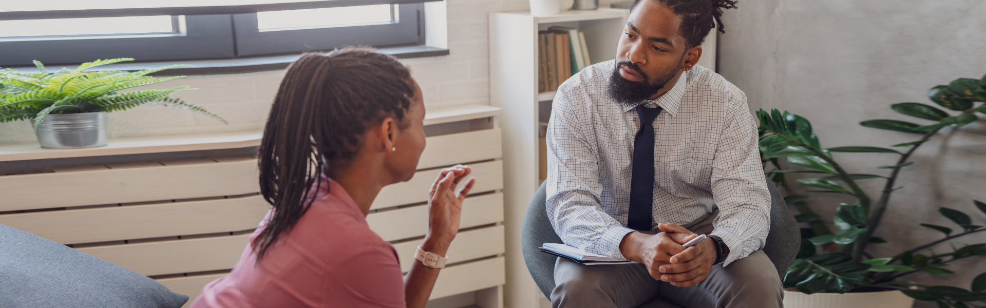 A psychotherapist session with a patient. African American woman and man have a meeting.