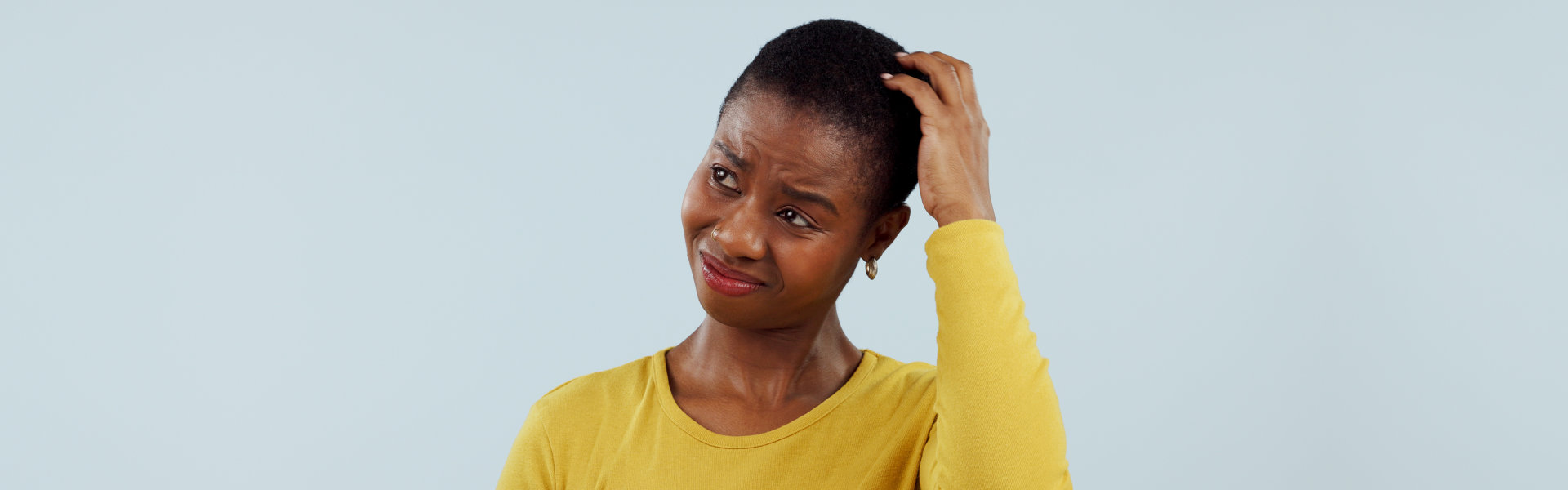 Confused, thinking and black woman scratching head in studio with why, brainstorming or solution on grey background. Questions, doubt and model with emoji gesture for problem solving, how or forget