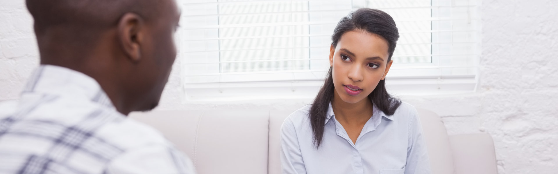 Man sitting with therapist taking notes