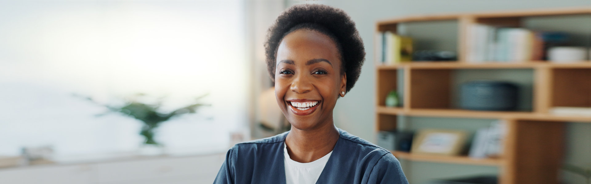 Black woman, nurse and happy face in nursing home in healthcare and volunteer with confidence in li